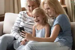 Grandparents relaxing at home with their granddaughter
