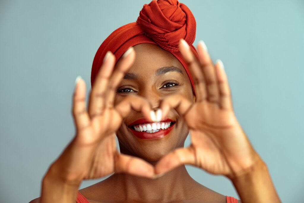 Woman framing her smile with her hands