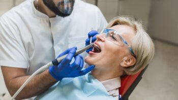 Dentist examining an older patient’s teeth
