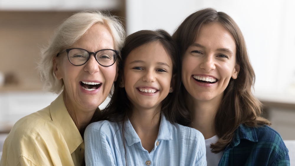 Three generations of women smiling together